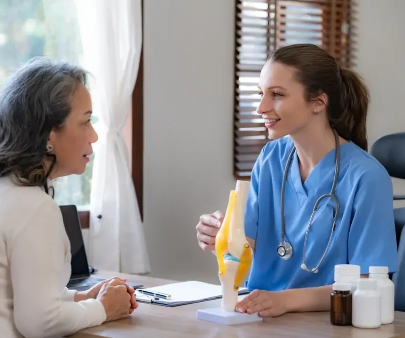 female doctor is checking an elderly female patient