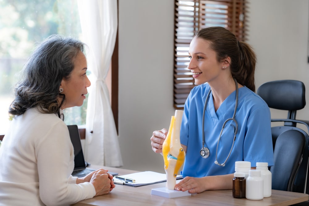 female doctor is checking an elderly female patient