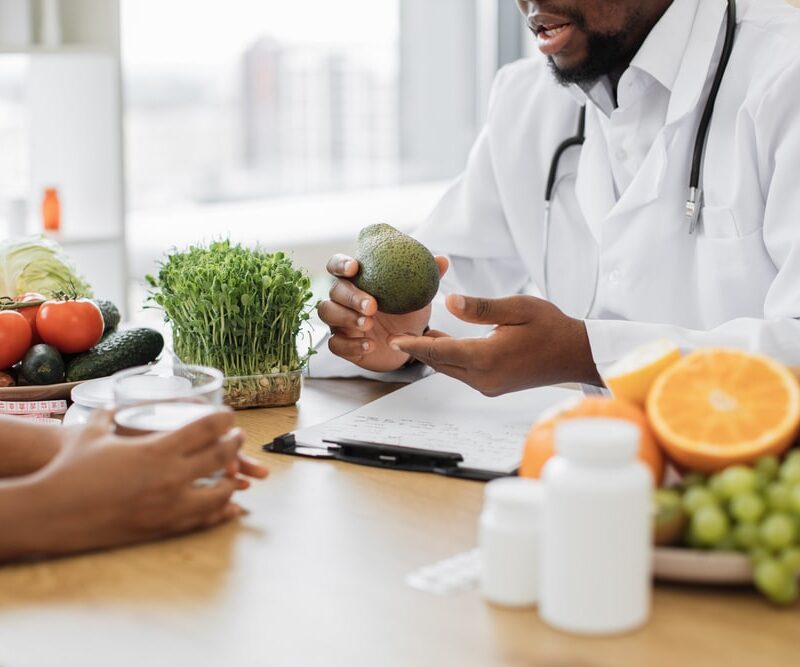 doctor with green fruit giving healthcare tips