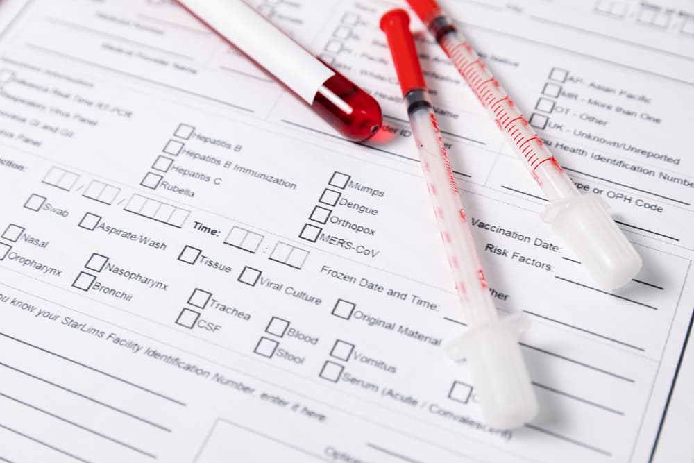 medical report with tubes of blood