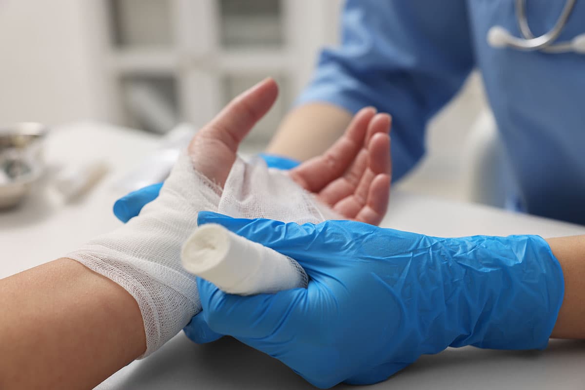 Clinician cleaning and closing a cut at Advanced Urgent Care of Pasadena